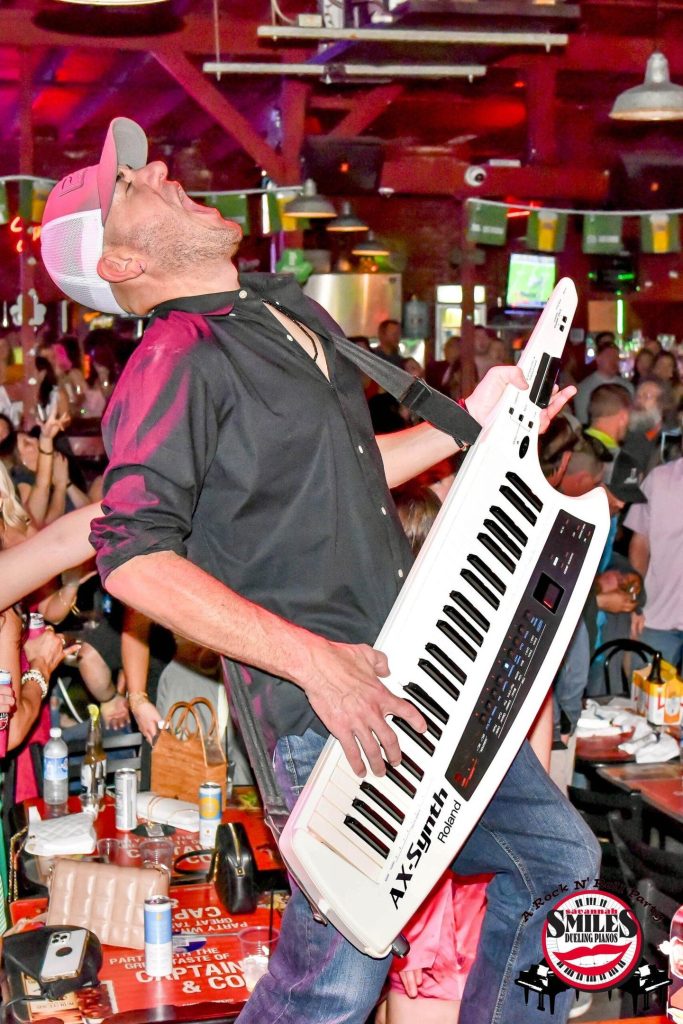 Savannah Smiles entertainer rocking a keytar on stage